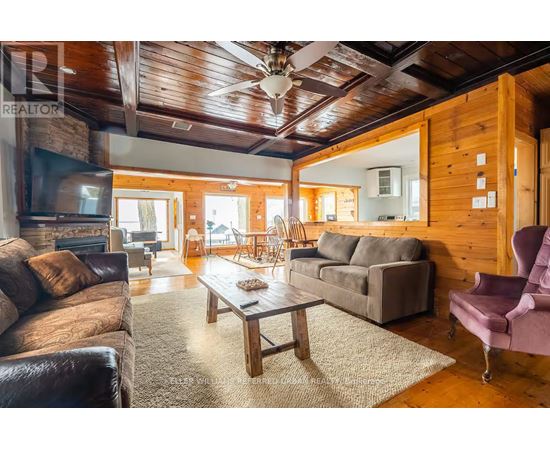 A living room with a brown leather couch and a wooden coffee table.