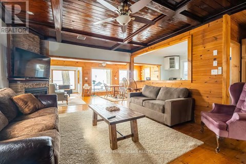 A living room with a brown leather couch and a wooden coffee table.