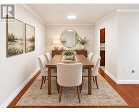A dining room with a wooden table and chairs.
