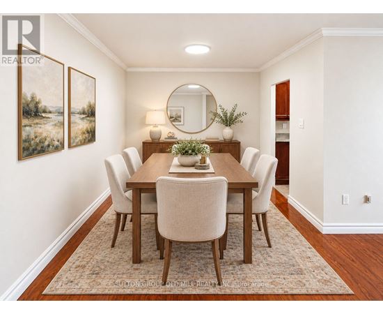 A dining room with a wooden table and chairs.