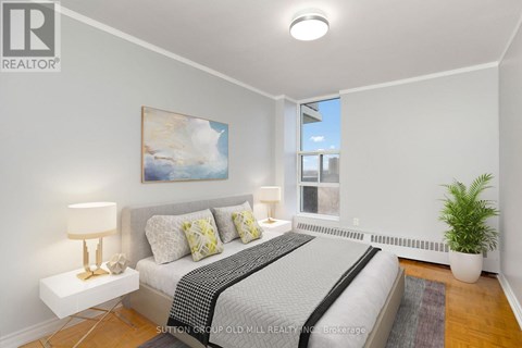 A bedroom with a bed, nightstands, and a painting on the wall.