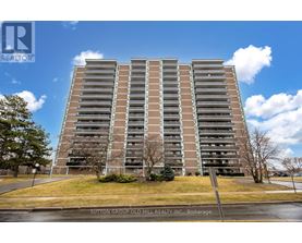 A tall apartment building with a sign that says Sutton Group Old Mill Realty, Brokerage.