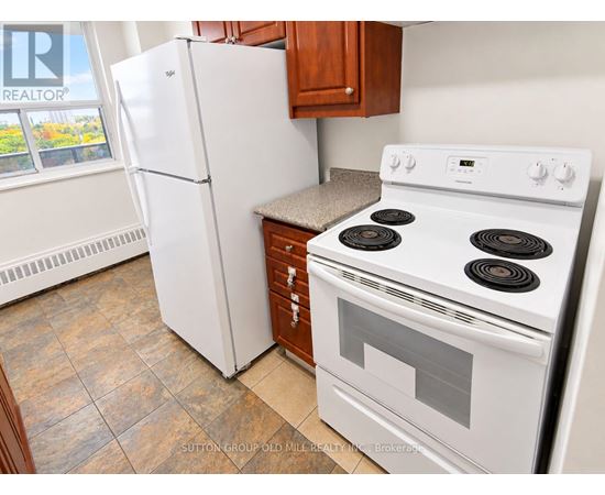 A white stove and refrigerator in a kitchen.