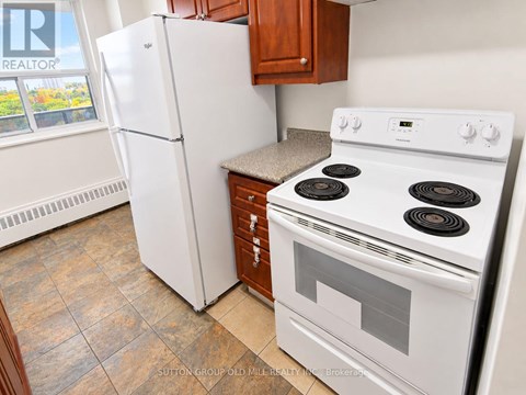 A white stove and refrigerator in a kitchen.