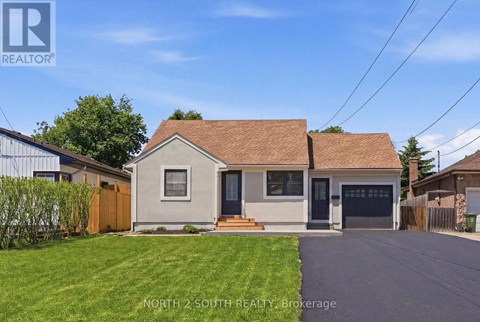 A house with a brown roof and a garage door is for sale.