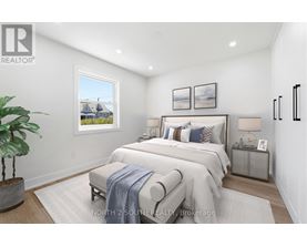 A bedroom with a large bed and a potted plant.