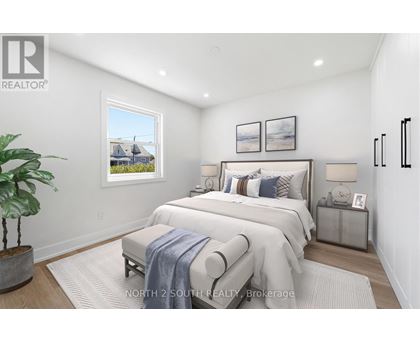 A bedroom with a large bed and a potted plant.