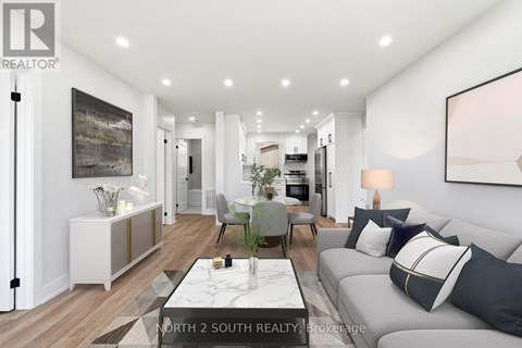 A modern living room with a grey sofa and a coffee table.