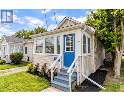 A small house with a blue door and a porch.