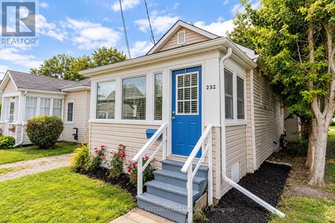 A small house with a blue door and a porch.
