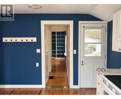A kitchen with blue walls and white cabinets.