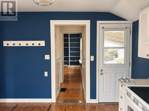 A kitchen with blue walls and white cabinets.