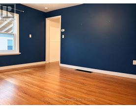 A room with a wooden floor and a door.