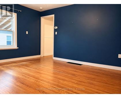 A room with a wooden floor and a door.