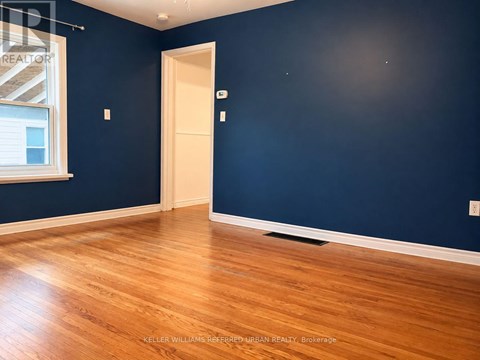 A room with a wooden floor and a door.