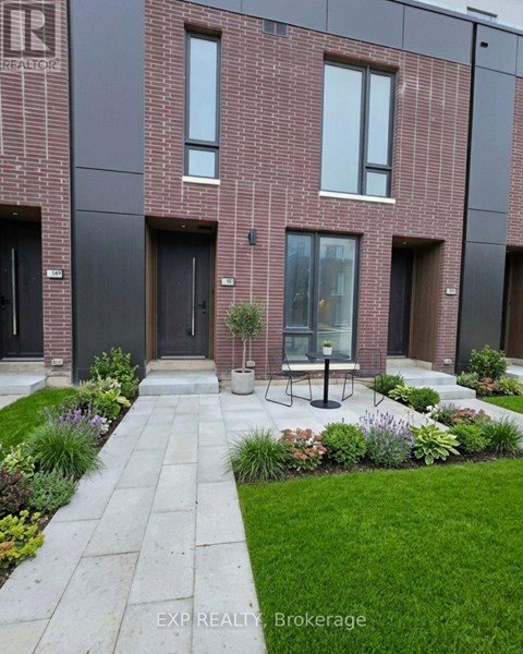 A modern brick building with a garden in front.