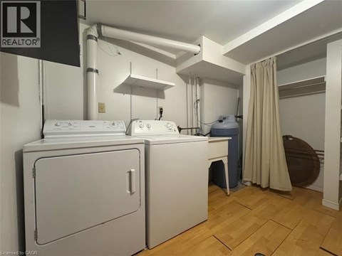 A small room with a washing machine and a dryer.