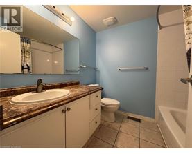 A bathroom with blue walls and a brown granite countertop.