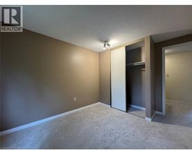 A room with a carpeted floor and a doorway leading to another room.