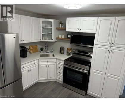 A kitchen with white cabinets and stainless steel appliances.
