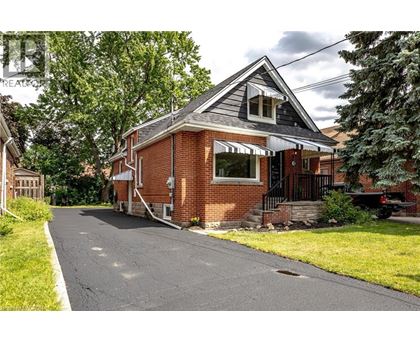 A house with a red brick exterior and a white window.