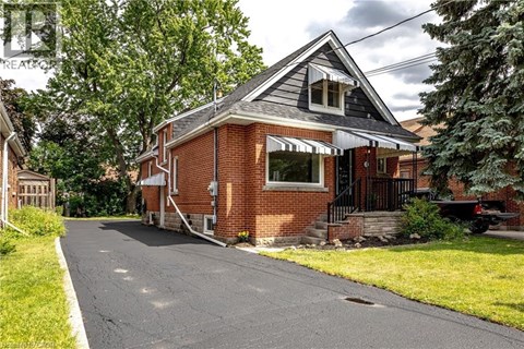 A house with a red brick exterior and a white window.