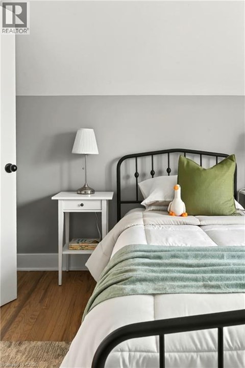 A bedroom with a white bed and a green pillow.