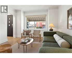 A living room with a green couch and a coffee table.