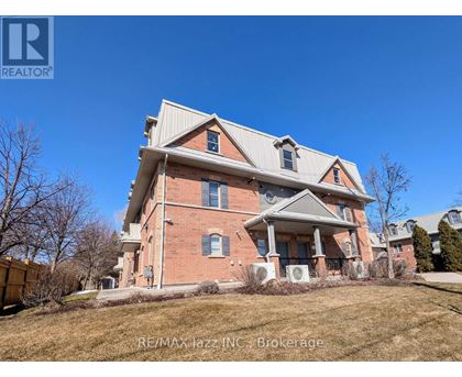 A large red brick house with a white roof and a large front porch.