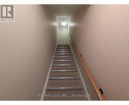 A long flight of stairs leading to a light at the end.