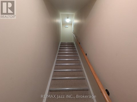 A long flight of stairs leading to a light at the end.