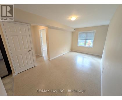 A room with a door, a window, and a light on the ceiling.