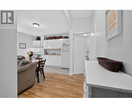 A white kitchen with a dining table and chairs.