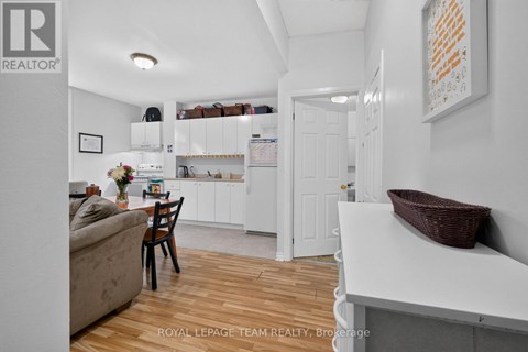 A white kitchen with a dining table and chairs.