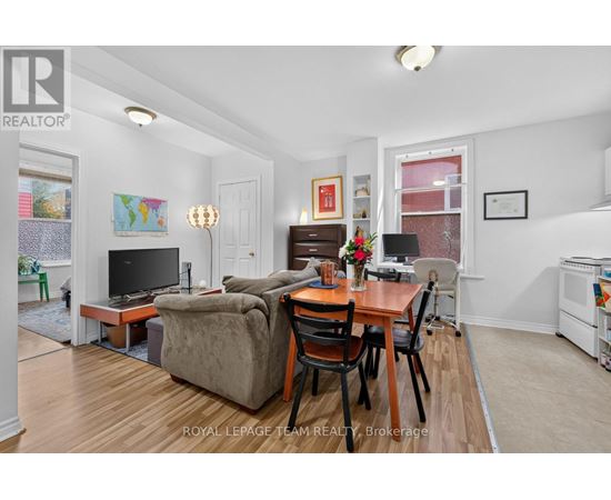 A living room with a brown couch and a wooden table.
