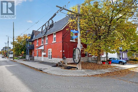 A red brick building with a sign that says "Royal LePage Team Realty, Brokerage" in front of it.