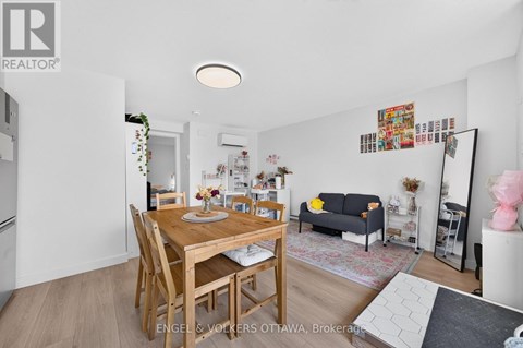 A dining room with a wooden table and chairs.