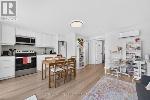 A kitchen with a table and chairs in the middle of the room.