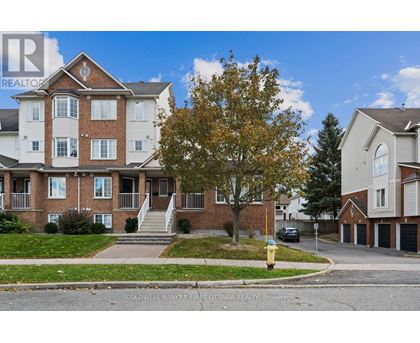 A large brick apartment building with a tree in front of it.
