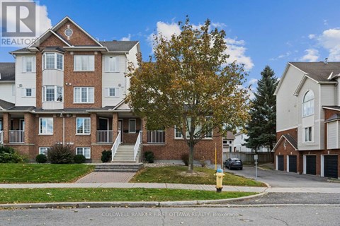 A large brick apartment building with a tree in front of it.