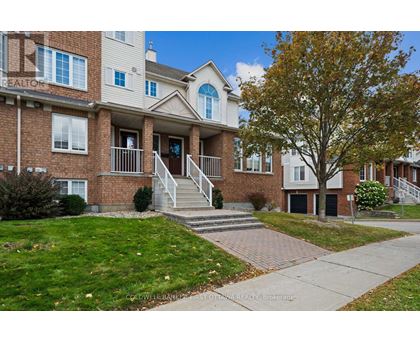A brick apartment building with a tree in front.