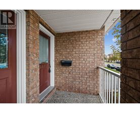 A red door is on the left side of a brick wall.
