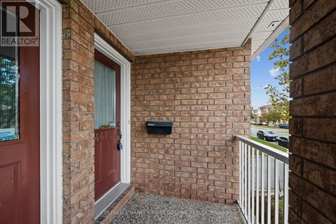 A red door is on the left side of a brick wall.