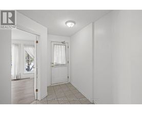 A white room with a door and a window.