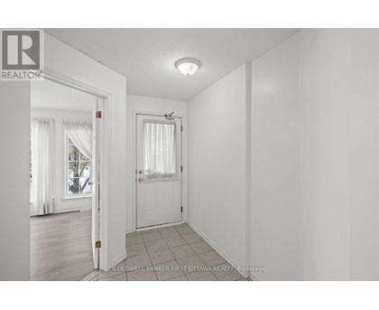 A white room with a door and a window.
