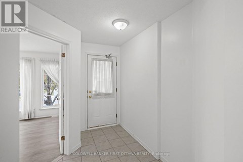 A white room with a door and a window.