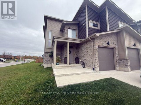A modern house with a stone wall and a garage door.
