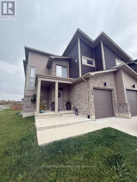 A modern house with a stone pillar in front.