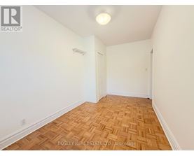 A room with wooden flooring and white walls.