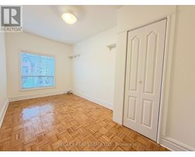 A room with a wooden floor and a white door.